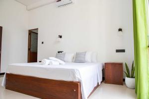 Postel nebo postele na pokoji v ubytování Randon Resort Mirissa
