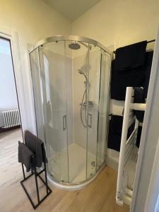 a shower with a glass enclosure in a room at Logis Saint Vivant in Volnay