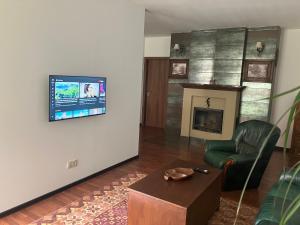 a living room with a fireplace and a tv on a wall at Kosice in Košice