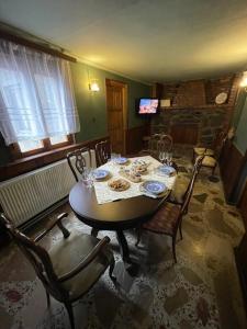 a dining room with a table and chairs at Milorava's Guest House & Wine Cellar in Tʼelavi