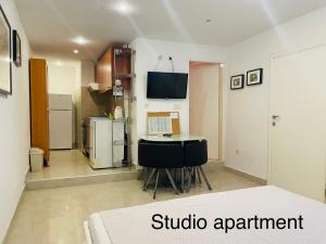 a room with a table and a kitchen with a refrigerator at Lili apartman in Vodice
