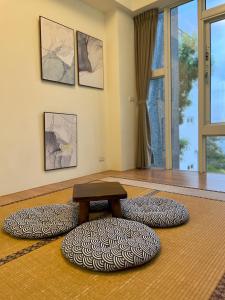 a room with two large circular mats on the floor with a table at I Leisure B&B in Yuanshan