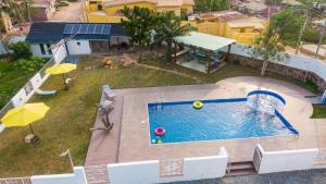 an overhead view of a swimming pool in a backyard at Inviting 3-Bed House in Awoshie Accra in Kwashieman