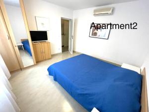 a bedroom with a blue bed in a room at Lili apartman in Vodice