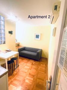 a living room with a couch and a table at Lili apartman in Vodice