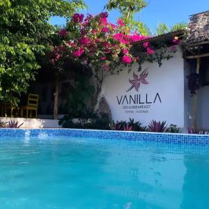 um sinal para uma villa com piscina em Vanilla em Nungwi