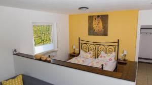 a bedroom with a bed and a window at Weingut Roth in Kindel