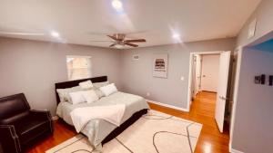 a bedroom with a bed and a ceiling fan at Cincinnati Cozy Entertainment home downtown in Cincinnati