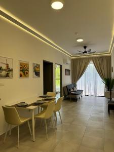 a living room with a dining room table and chairs at Sandakan Blue Coastal escape 蓝海岩栖 in Sandakan