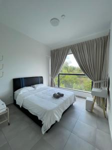 a bedroom with a large bed and a large window at Sandakan Blue Coastal escape 蓝海岩栖 in Sandakan