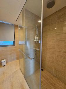 una ducha con puerta de cristal en un baño en Batu Ferringhi By The Sea 2BR Suite 6 Pax, en Batu Ferringhi