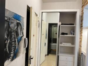 a painting of an elephant on a wall in a hallway at Cozy apartment in the city center Mtatsminda in Tbilisi City