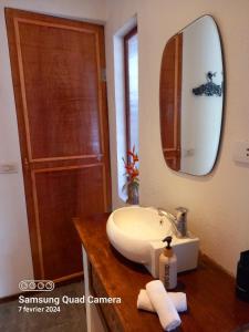 a bathroom with a sink and a mirror at Valerie Lodge in San Vicente