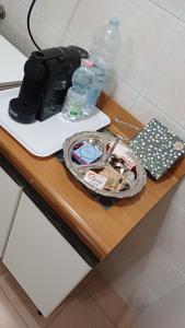 a table with a bag and water bottles on it at Savena House in Bologna
