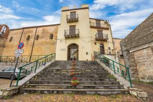 a building with stairs in front of a building at Isnello, 25 min PianoB. & Cefalù in Isnello