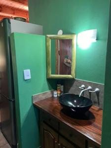 a bathroom with a black sink and a mirror at Departamento con vista al lago in Puerto Libertad