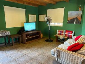 a living room with a flat screen tv and a couch at Departamento con vista al lago in Puerto Libertad