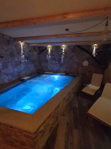 a large swimming pool in a stone room with at Agriturismo La Soglia Del Parco in Ranica