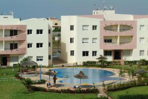 un resort con una grande piscina di fronte a un edificio di Mohammedia Plage et piscines a Mohammedia