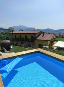 a swimming pool in front of a house at Agriturismo La Soglia Del Parco in Ranica