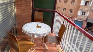 a table and chairs on a balcony with a bird on it at Piso para compartir in Santa Coloma de Gramanet