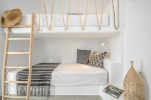 a bedroom with a bunk bed and a ladder at Casa Rakan in Naxos Chora