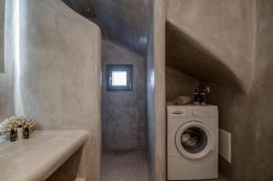 a bathroom with a washing machine and a sink at Casa Rakan in Naxos Chora