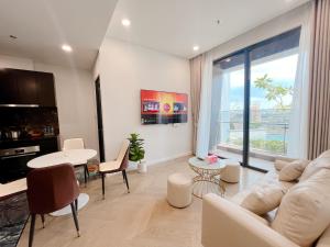 a living room with a couch and a table at THE LUMIÈRE RIVERSIDE LUXURY SUITE in Ho Chi Minh City