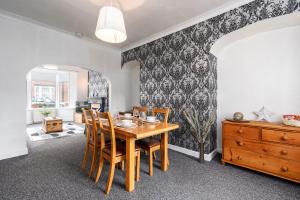 a dining room with a wooden table and chairs at Bishop's Little Palace in Bishop Auckland