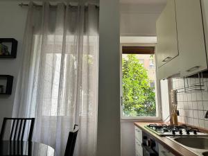 a kitchen with a window and a table and a sink at COSENZA Galluppi 23 in Cosenza