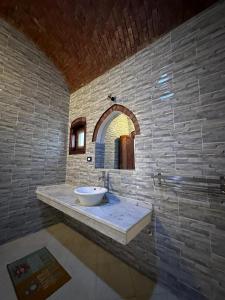 a bathroom with a sink in a brick wall at Oriental house in Luxor