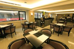 ein Restaurant mit Tischen und Stühlen und eine Bar in der Unterkunft Nest Hotel in Kaohsiung + 33 Fotos