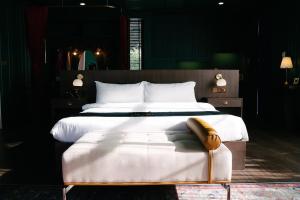 a bedroom with a large bed with a wooden headboard at The Sea-Cret Garden Hua Hin in Hua Hin
