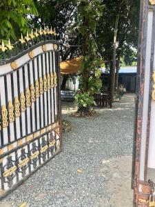 a iron fence with a gate in a yard at Villa Garden Apart & swimming pool in Kampot