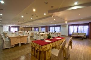 a banquet hall with white tables and chairs at Bella Villa Cabana in Naklua  +189 photos