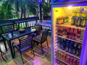 a refrigerator filled with lots of bottles of soda at beautiful pool house in Patong Beach