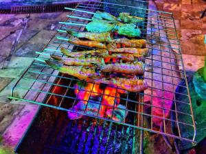 a bunch of food cooking on a grill at beautiful pool house in Patong Beach