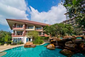 a hotel with a swimming pool and a resort at Bella Villa Cabana in Naklua 