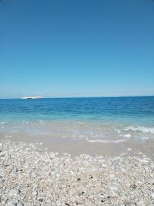 a beach with rocks and the blue water at Casa Anseramo in Bisceglie
