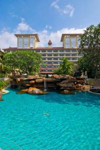 a hotel with a swimming pool in front of a building at Bella Villa Cabana in Naklua 