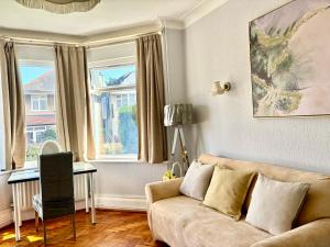 a living room with a couch and a table at Winton house home stay in Bournemouth