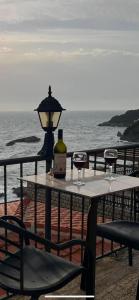 a table with a bottle of wine and a glass at Apartments Gusar in Ulcinj