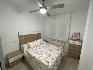 een slaapkamer met een bed en een plafondventilator bij Apartamento nuevo en Puertollano in Puertollano