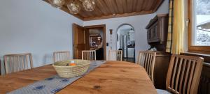 a dining room with a wooden table with a basket on it at Chalet Stuhlfelden in Stuhlfelden