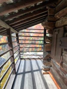 a wooden walkway in a cabin with a wooden wall at Cozy 500 Years Old Walser Home in Alagna Valsesia
