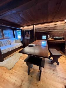 a living room with a table and a bed at Cozy 500 Years Old Walser Home in Alagna Valsesia