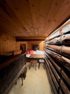 a room with a table and a bench in a cabin at Cozy 500 Years Old Walser Home in Alagna Valsesia