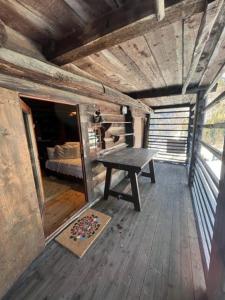 an inside view of a cabin with a table and a bed at Cozy 500 Years Old Walser Home in Alagna Valsesia