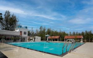 a large swimming pool with blue water at Lake View Village Resort in Tajpur