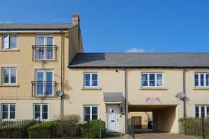 an apartment building with a garage at Sorrel House in Carterton